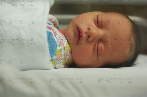 Head and Shoulders Portrait of Sleeping Newborn Baby Girl in Hospital