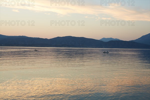 Fishermen at Dusk with Mountainous Landscape in Background, Patras, Greece