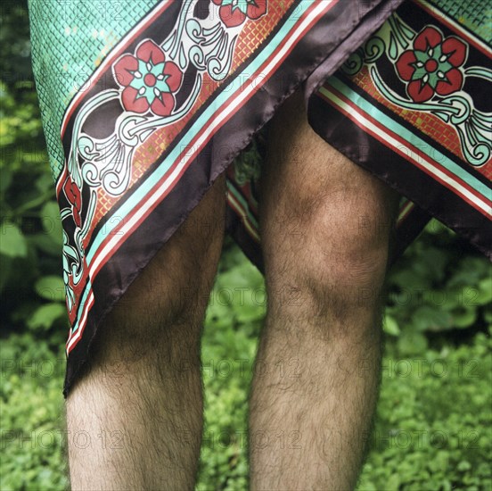 Mid-Adult Man's Hairy Legs with Skirt