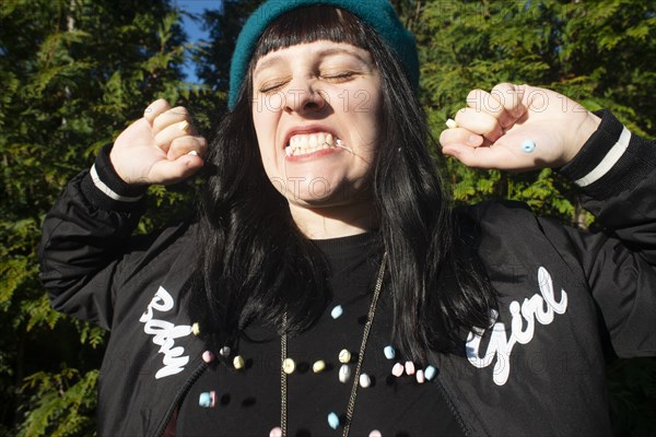 Young Adult Woman Eating Candy Necklace