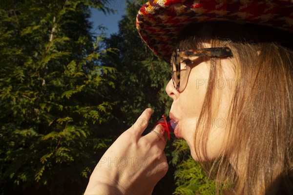 Mid-Adult Woman Sucking on Candy Diamond Ring