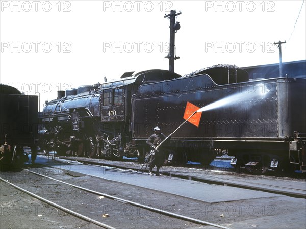 Worker Cleaning an engine near the Roundhouse