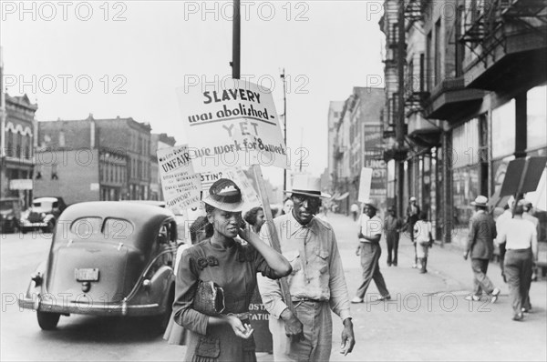 Group of People walking in Picket line at Mid-City Realty Company