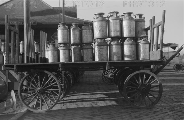 Milk cans at Railroad station. Minot