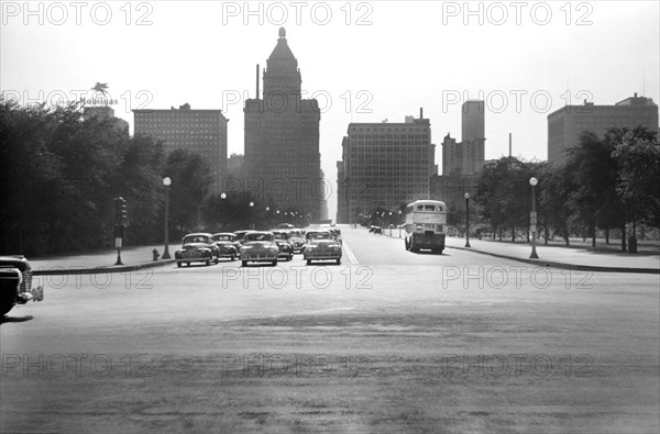 Cars stopped at Traffic Light on East Jackson Boulevard with Straus (left center