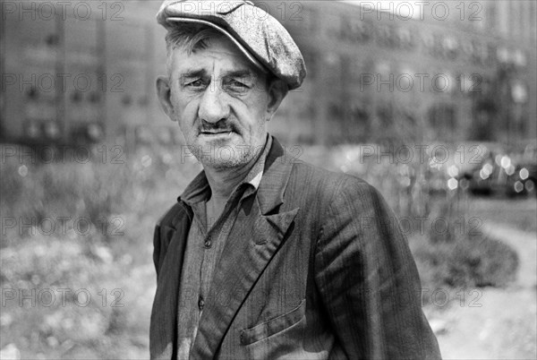 Head and Shoulders Portrait of Adult Man in Cap