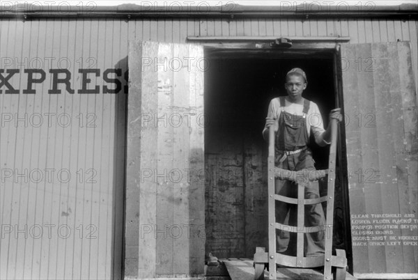 Migratory Worker Loading Sacks of Potatoes into Freight Car