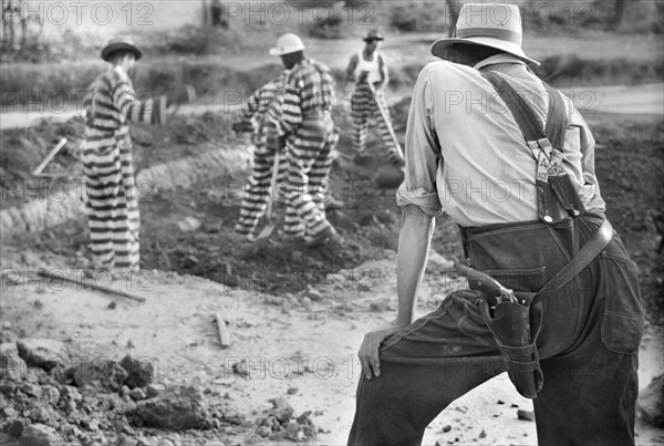 Guard watching Convicts working on Road