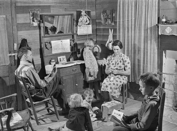 Mr. and Mrs. L. Smith and their younger Children in their Home on their Farm