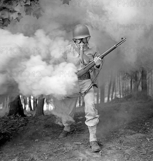 Sergeant George Camblair learning how to use a gas mask in a practice smokescreen