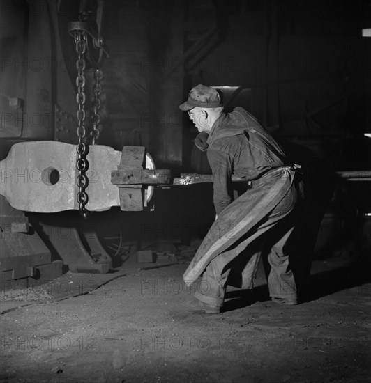 Workman manipulating a Hot Forging which is being hammered under a Steam Hammer at Blacksmith Shop of Atchison