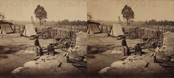 Two Soldiers sitting amid Confederate Weapons and Fortifications