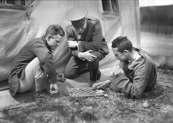 American Red Cross Man refereeing a Game of Checkers played by two Patients in the American Military Hospital No. 5