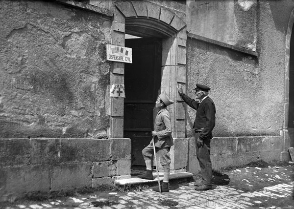 Small French boy wearing a Poilu's Cap calls for Medicine at American Red Cross Civil Dispensary