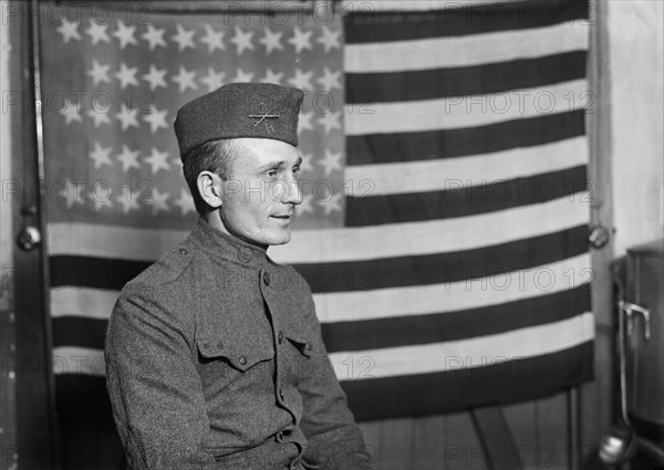 Half-Length Portrait of American Soldier with American Flag in Background