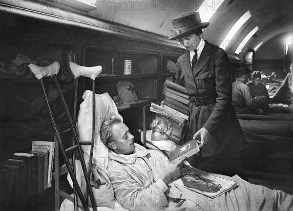 Injured American Soldier receiving Books supplied by American Red Cross at American Base Hospital No. 27