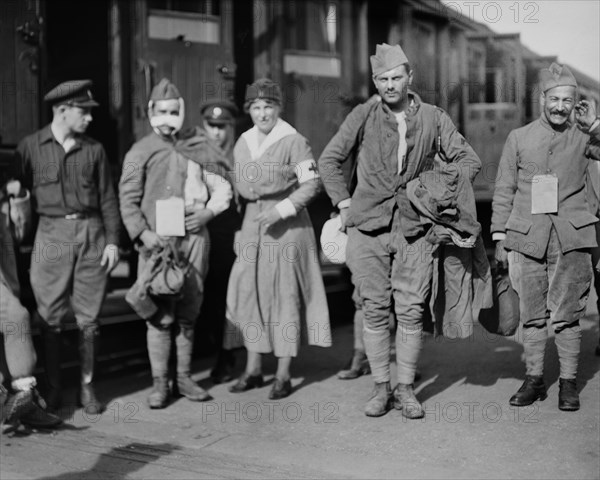 American Red Cross Nurse and Camion Driver assisting Wounded French Soldiers who have just arrived at Railroad Station