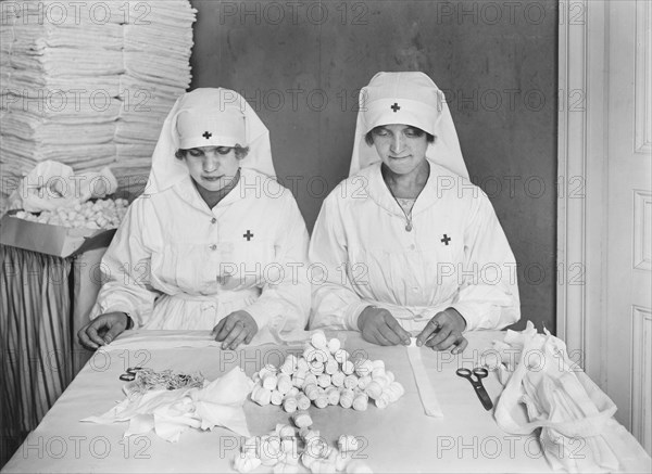 Two French Women employed by American Red Cross to mold Gauze Packing at American Red Cross Workrooms for Surgical Dressings