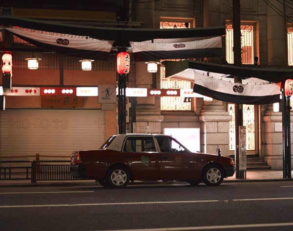 Taxi Parked on Street at Night