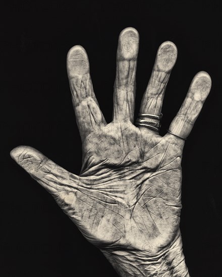 Elderly Hand against Black Background