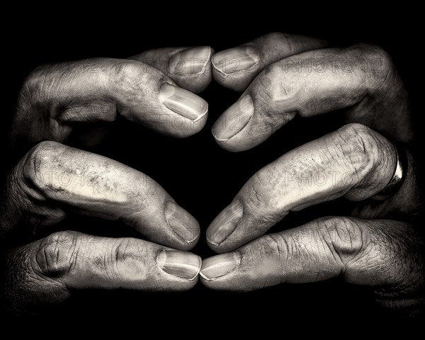 Close-Up of Touching Fingertips against Black Background