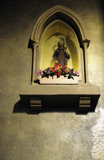 Holy Saint Icon on Exterior Building Wall at Night