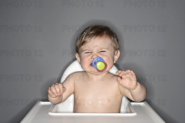 Crying Baby Boy with Pacifier in his Mouth