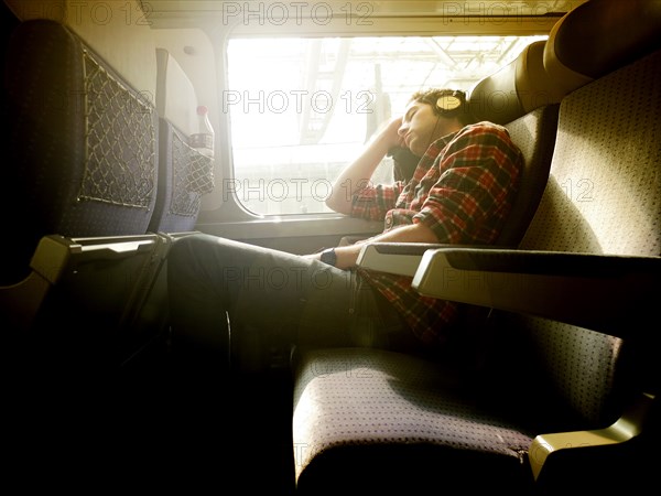 Young Man asleep on Train