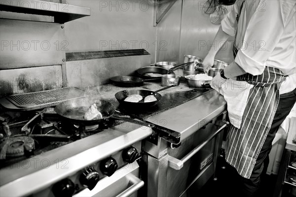 Chef putting Grated Cheese in Plastic Container