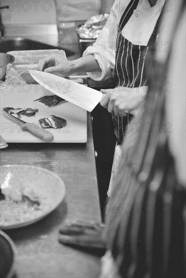 Chef Slicing Meat with Knife