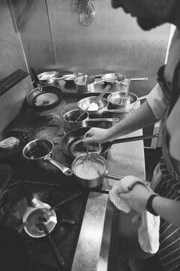 Chef stirring Sauce in Pan