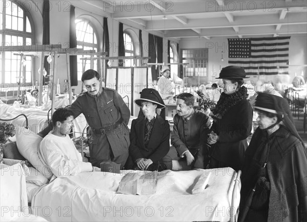 Relatives visiting a wounded French soldier in American Military Hospital No. 1 supported by American Red Cross