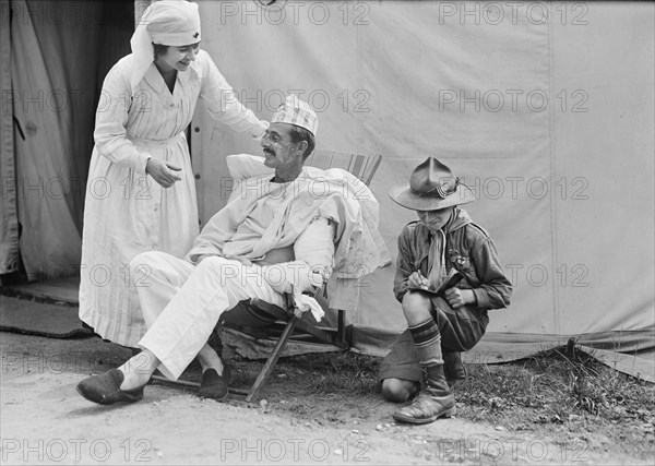 American Red Cross Nurse's Aide with injured American Soldier and Boy Scout