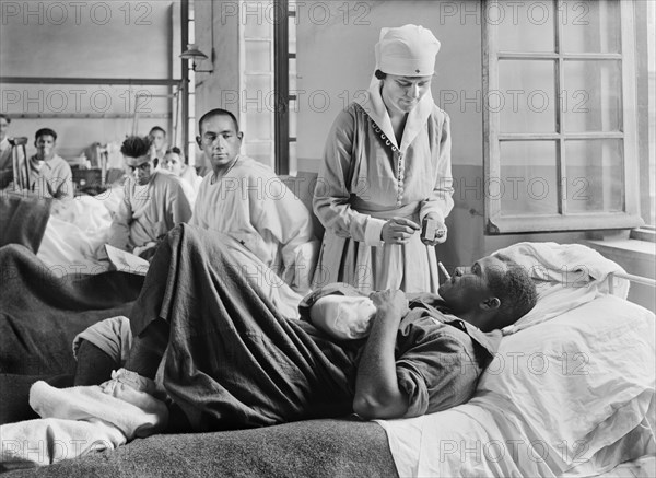 Injured American Soldier receiving Cigarette from American Red Cross Worker at Base Hospital 41