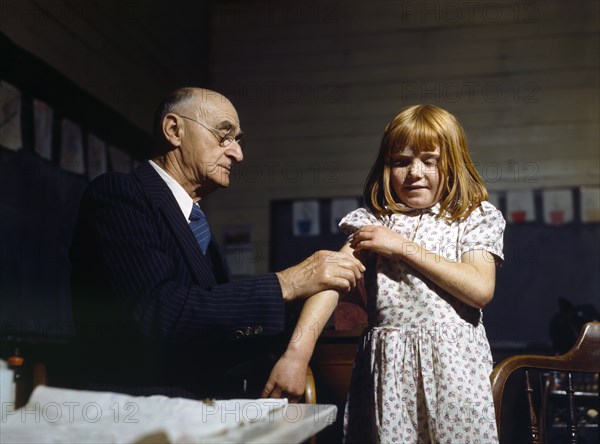 Dr. Schreiber of San Augustine giving a typhoid inoculation at a rural school