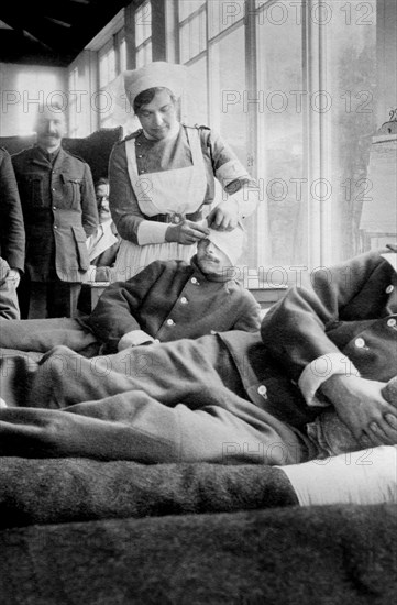 Nurse bandaging Head of Soldier at Canadian Base Hospital during World War I