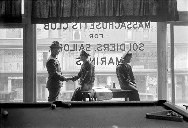 Soldiers and Sailors sitting in front of Window reading "Massachusetts Club for Soldiers