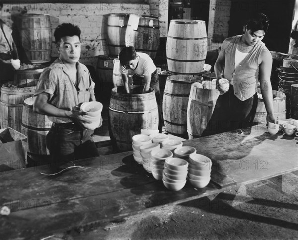 Dishes being unpacked for newly arrived Evacuees of Japanese Ancestry at Assembly Center