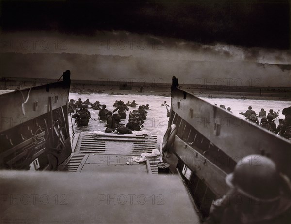 American Soldiers wading from Coast Guard landing barge toward Beach at Normandy