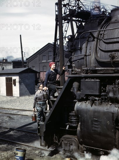 Mrs. Viola Sievers and Mrs. Marcella Hart cleaning one of the giant "H" Class Locomotives
