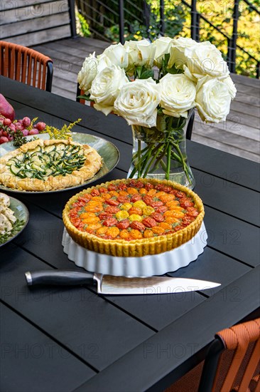 Tomato and Zucchini Tarts on Table in Outdoor Setting