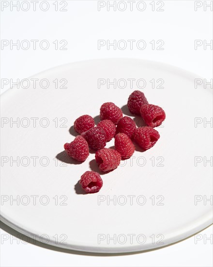 Raspberries on Cropped White Plate