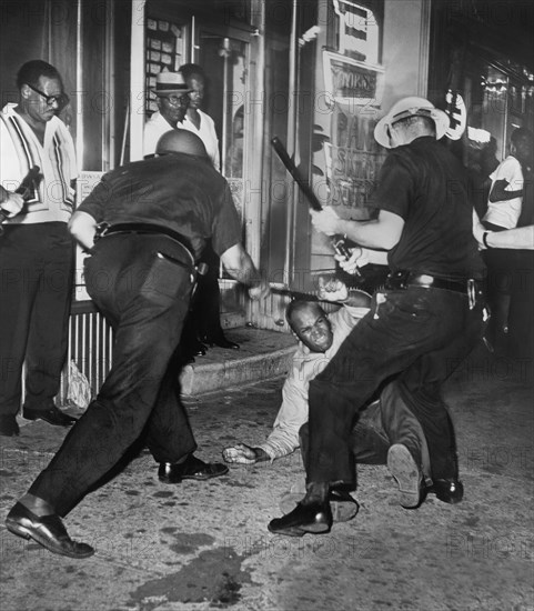 African American Man being beaten by Police after night of rioting due to shooting of Teen James Powell by Police Officer Lt. Thomas Gilligan, 133rd St. and Seventh Avenue, July 1964