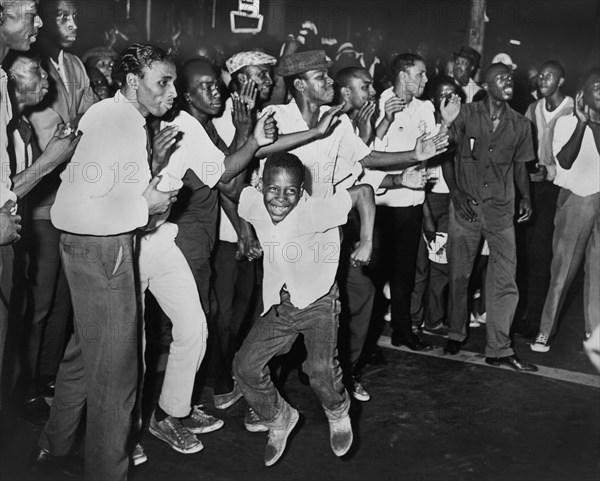 Crowd chanting and Taunting Police after rioting due to fatal shooting of Teen James Powell by Police Officer Lt. Thomas Gilligan, Harlem, July 1964