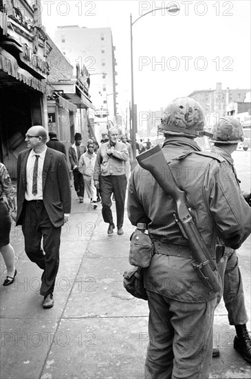 Members of National Guard patrolling streets as pedestrians walk by after riots following Dr. Martin Luther King Jr's, Assassination, April 8
