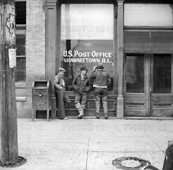 Three Men hanging out in front of U.S. Post Office, Shawneetown, April 1937
