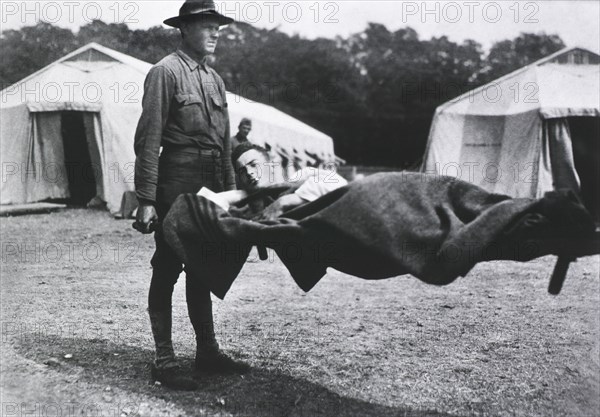 Patient being transported on Stretcher, Two Tents in background, 1914-1918