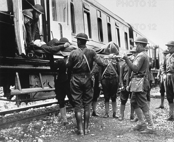 Group of Soldiers carrying Wounded Men aboard  Hospital Train, Herouville, 1918