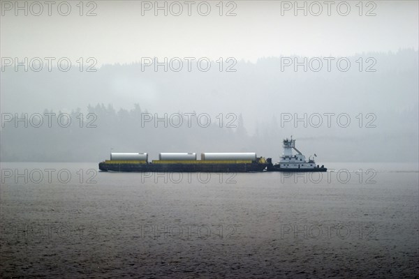 Barge in Columbia river, wildfire smoke obstructing distant view,