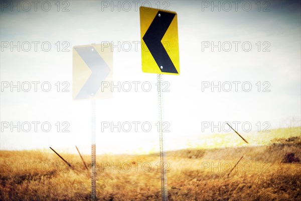 Directional Road Signs in Rural Landscape,,